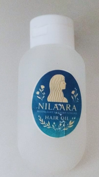 Nilaara Hair Oil bottle with blue botanical label